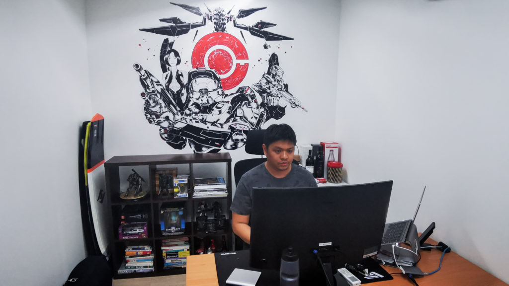 man on his customized work station with wall painting 