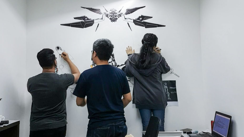 KDCI three people painting on wall 2