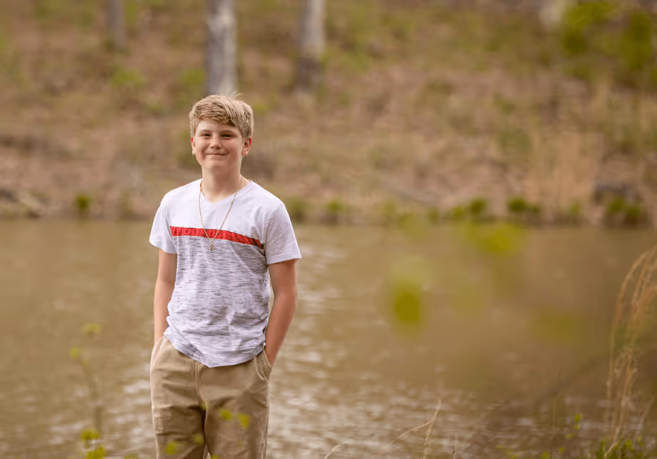boy standing near lake