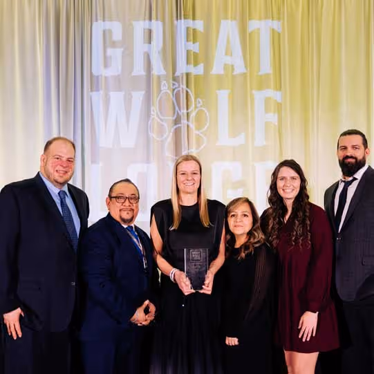 Great Wolf Lodge Pack Members pose with an award