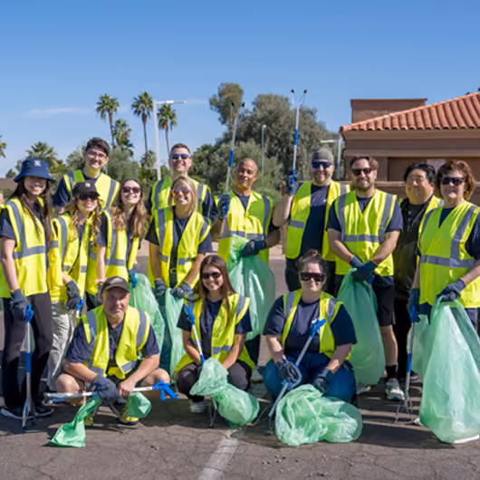 Pack Members posing for photo with their bags of trash