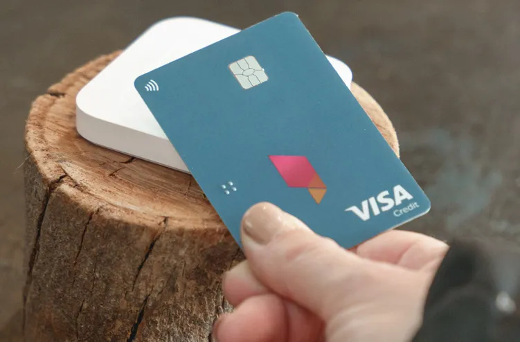 Bank Australia Visa credit card with a notebook and laptop on a blue table