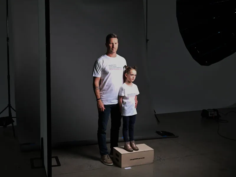 A customer and his daughter pose in Bank Australia T-Shirts for the Bank Australia needs campaign.