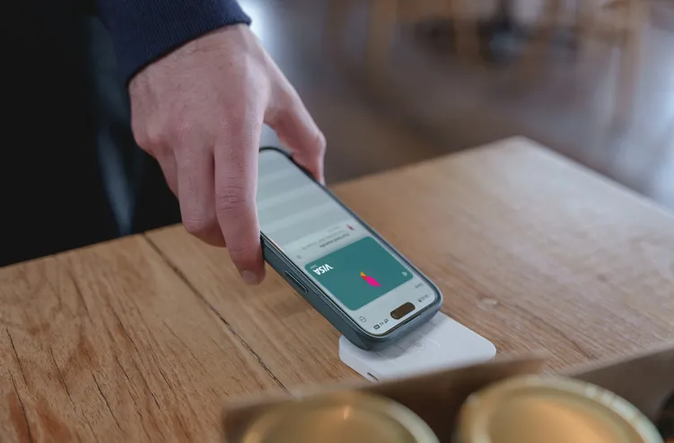 A person checks their digital banking account on her phone