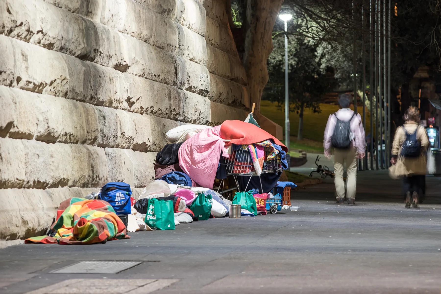 The belongings of a homeless person. A shopping trolley is filed with blankets, bags and other assorted items