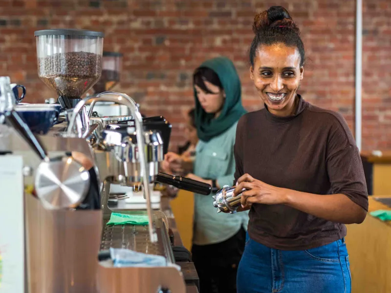 Two people make coffee