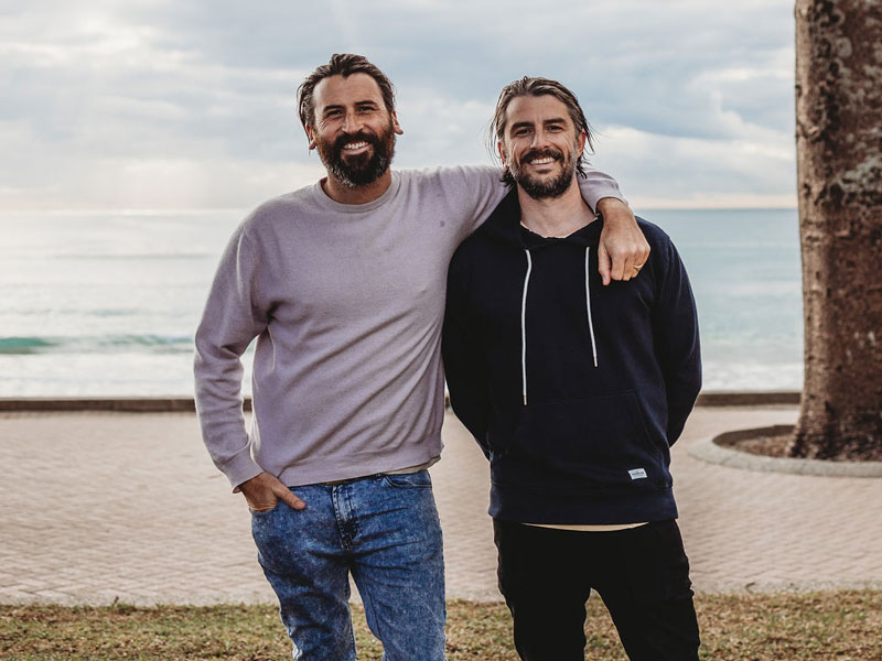 Ocean Impact Organisation founders stand together at a beach