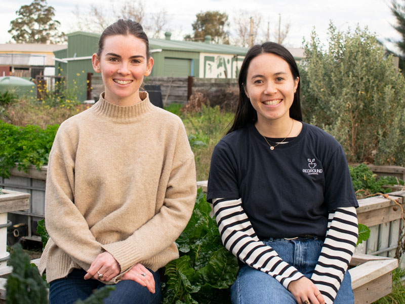 reground founders sit together in a community garden