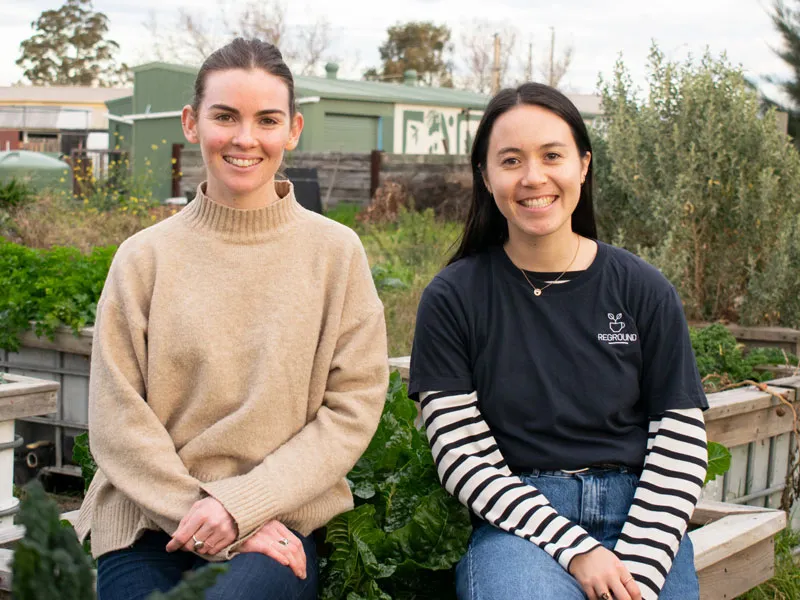 reground founders sit together in a community garden