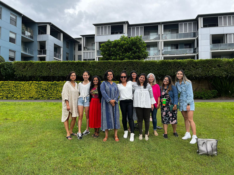 Women of Colour Australia stand together outside