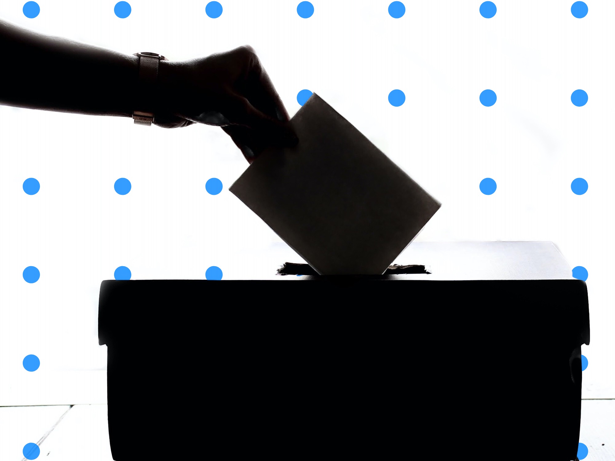 Hand dropping a completed ballot in a ballot box