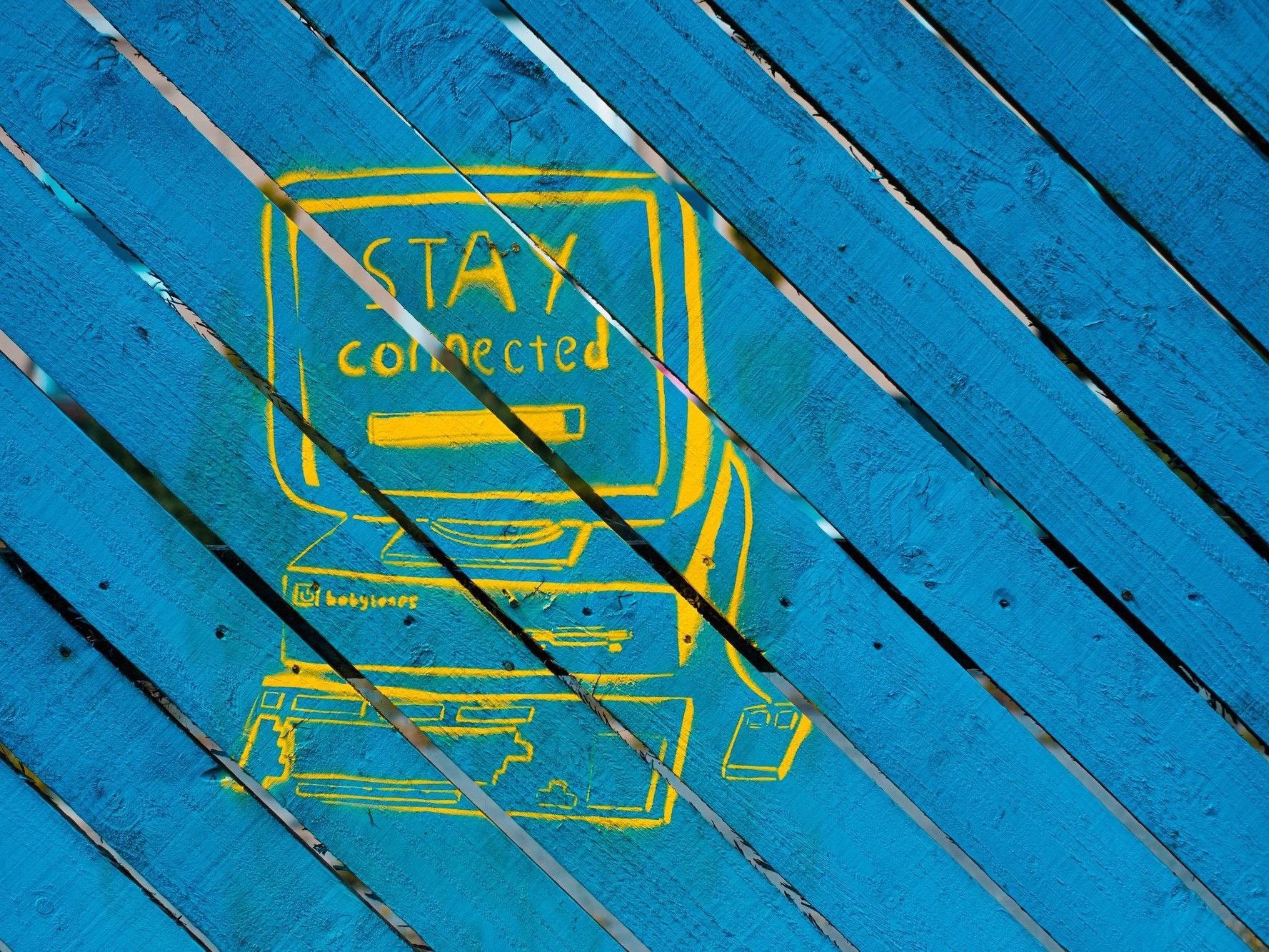 Mural of an image saying stay connected on blue wooden backdrop