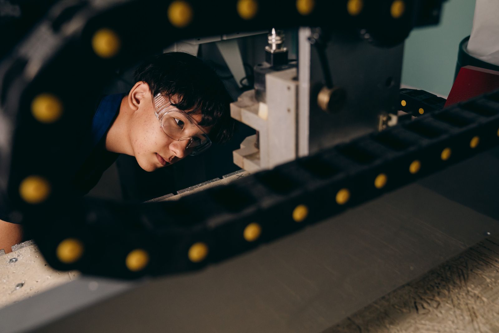 Engineer inspecting industrial machinery in a factory, representing supplier vetting before offshore manufacturing