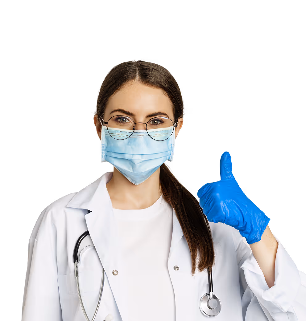 Female healthcare professional wearing a surgical mask, glasses, and blue gloves giving a thumbs-up.