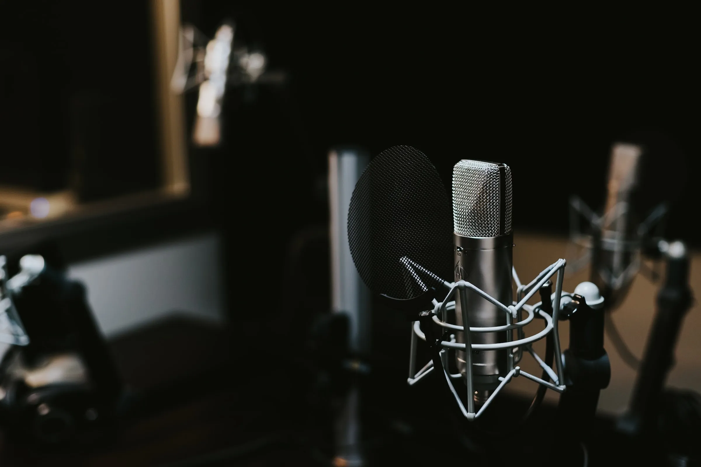 A close up of a microphone with a mirror in the background.