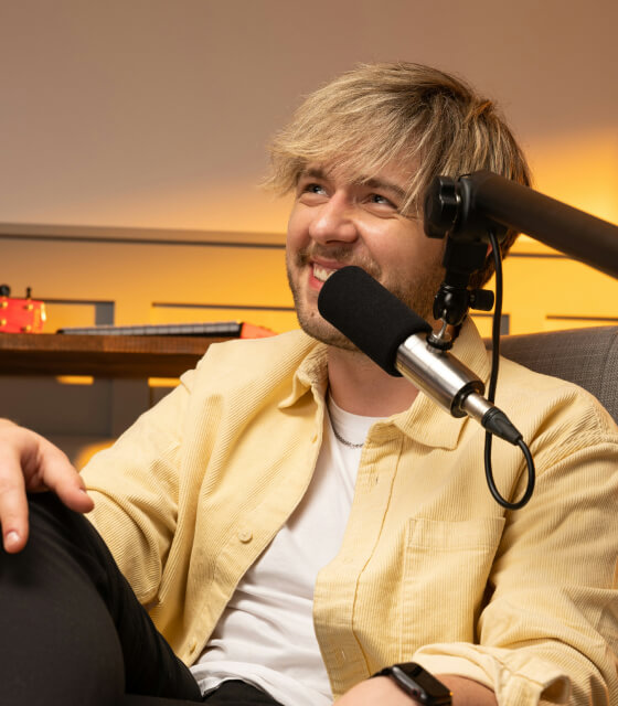 Alex Sterling, host of Podspace, speaking into a studio microphone