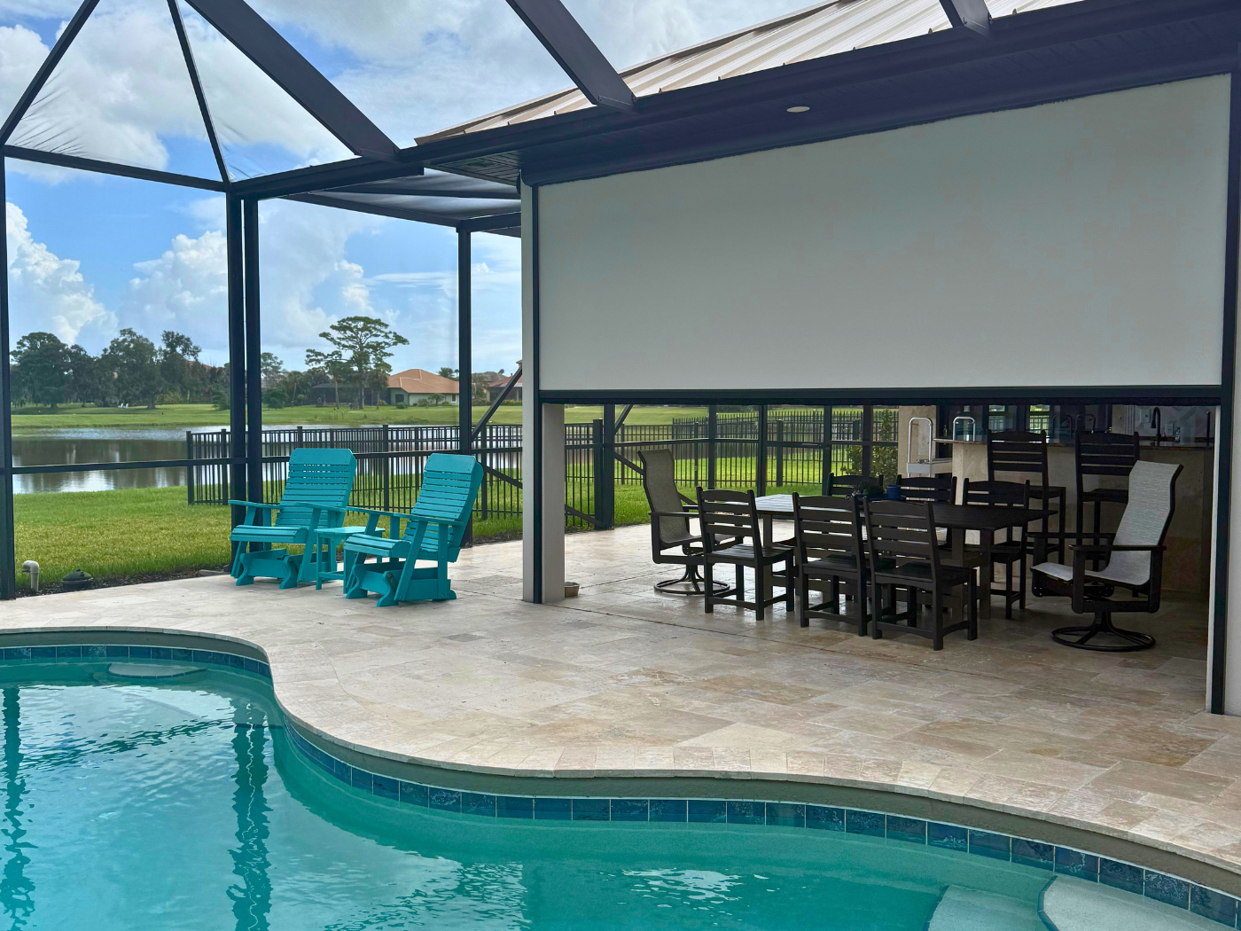 Tan dimout motorized screen inside a pool screen enclosure in Rockledge, FL