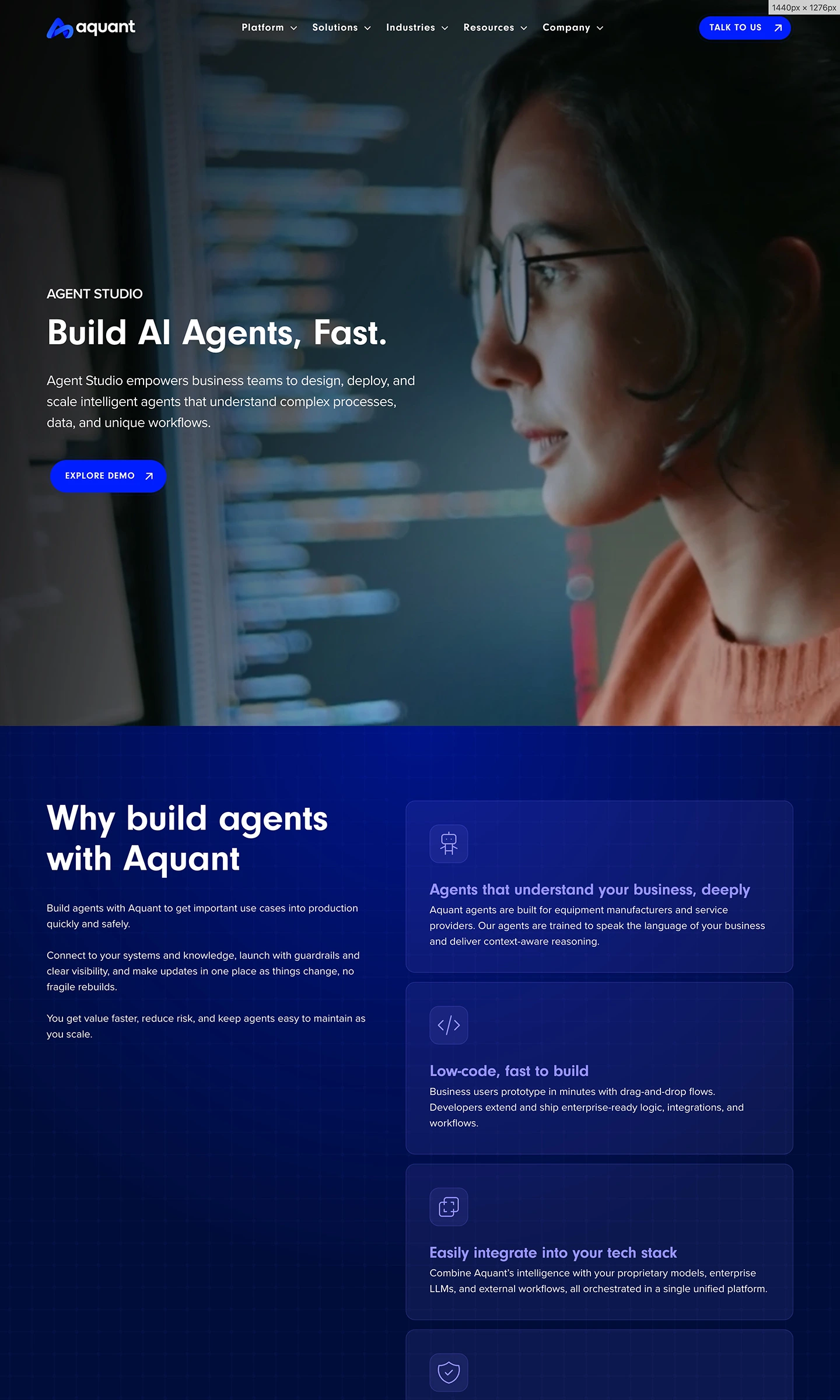 Person with glasses looking at a computer screen with code and Aquant AI agent studio webpage text.