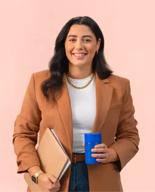 A head of department holding a laptop and an Atomi coffee cup