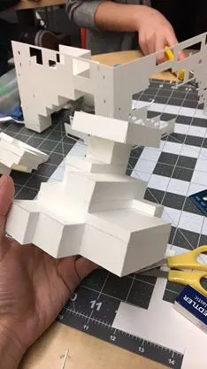 Cardstock paper being shaped into rectangular blocks