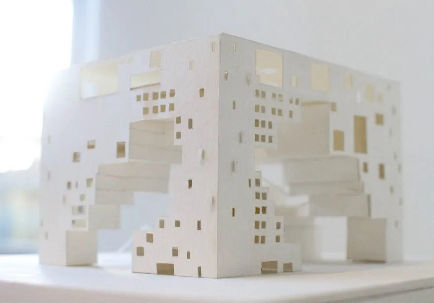 An aerial perspective of a paper model depicting a rectangular building