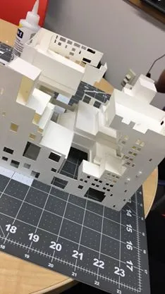 Cardstock paper being shaped into rectangular blocks sitting on top of a cutting mat