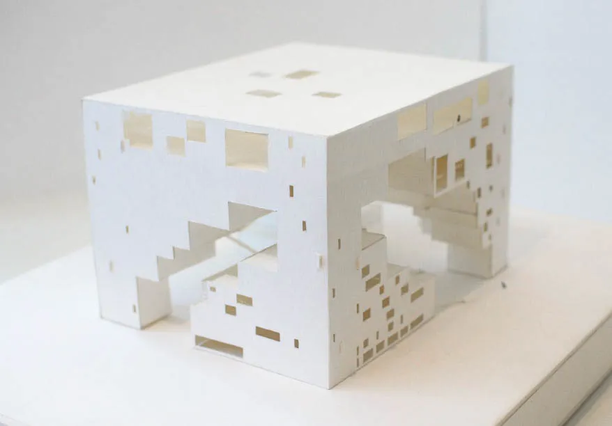 An aerial perspective of a paper model depicting a rectangular building