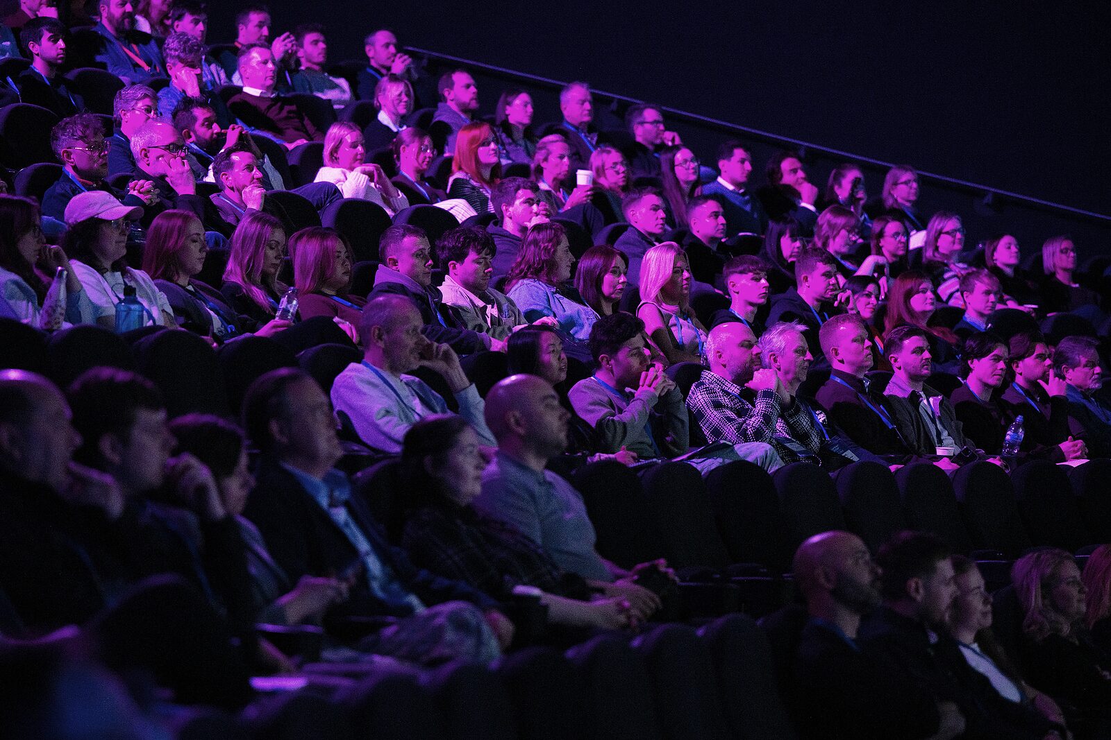 A full house of attendees in the tiered IMAX seats