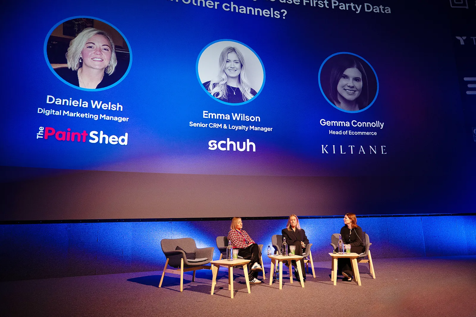 Three panellists on the IMAX stage under a big-screen slide naming Daniela Welsh of The Paint Shed, Emma Wilson of schuh and Gemma Connolly of Kiltane