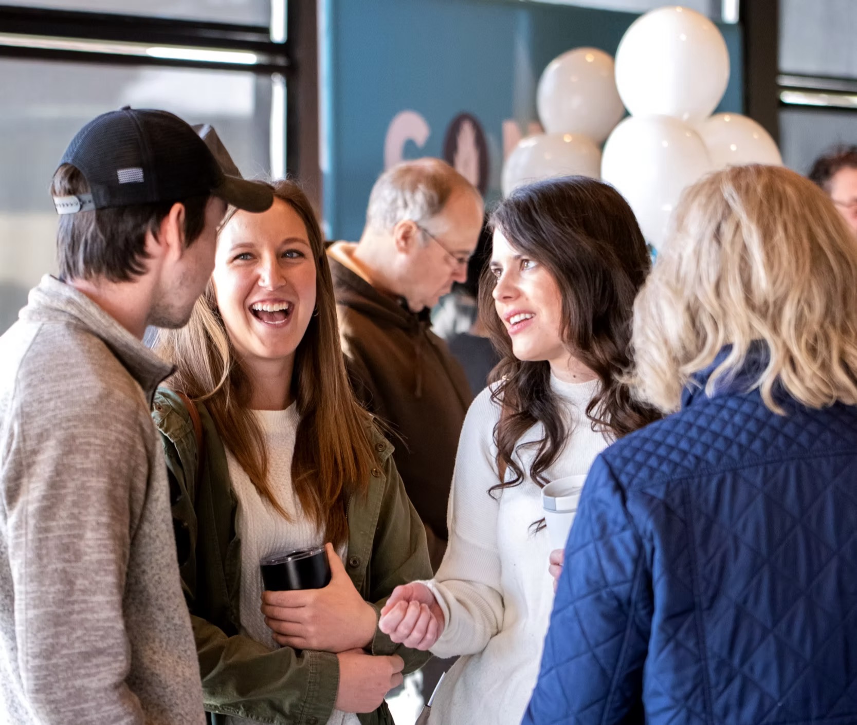 An image of the Church of the Harvest Olathe lobby before service. Photo shows members of the congregation socializing and enjoying one another's company. 