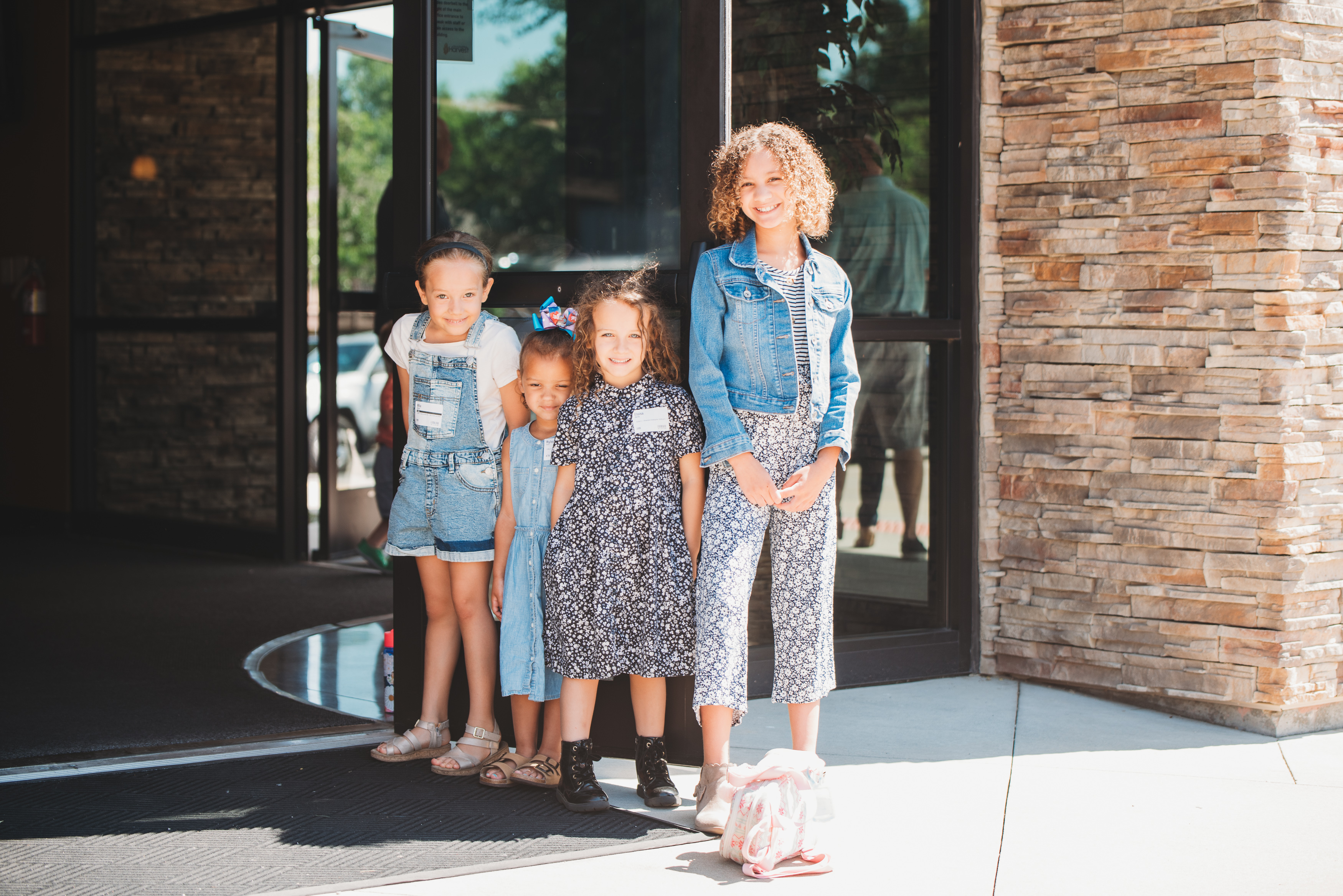 Four young ladies greeting church goers on Sunday.