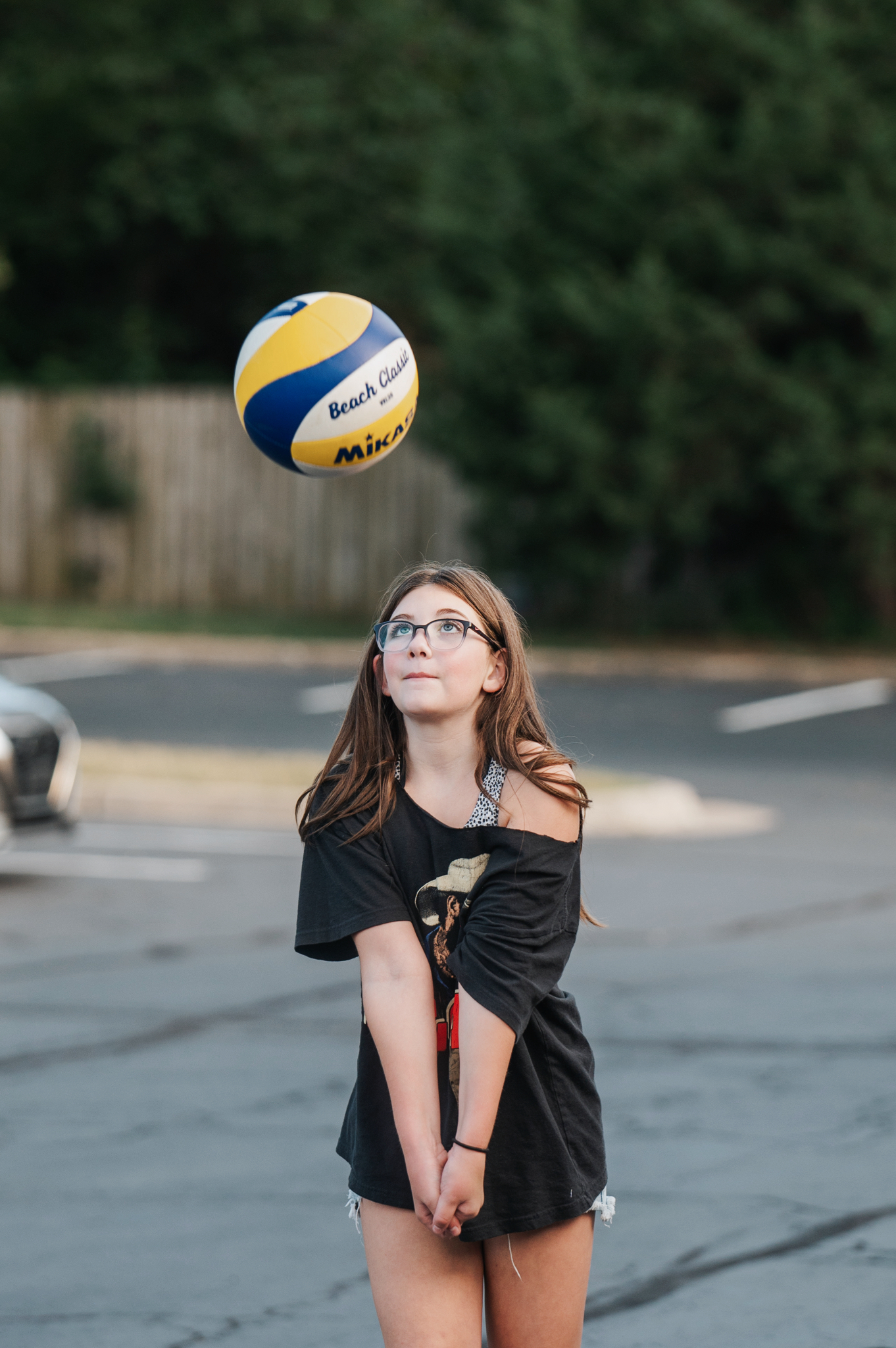 A young girl playing volleyball at youth group