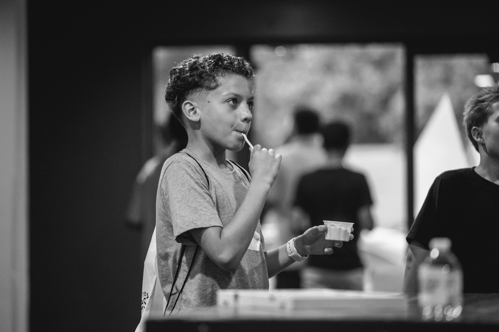 A young boy eating ice cream before youth group