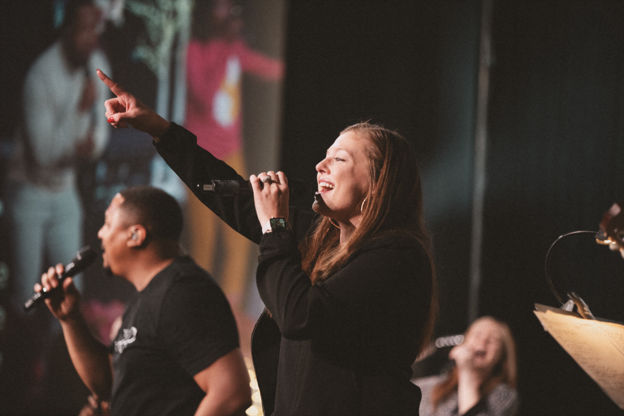 Noel Augustine on stage leading worship 