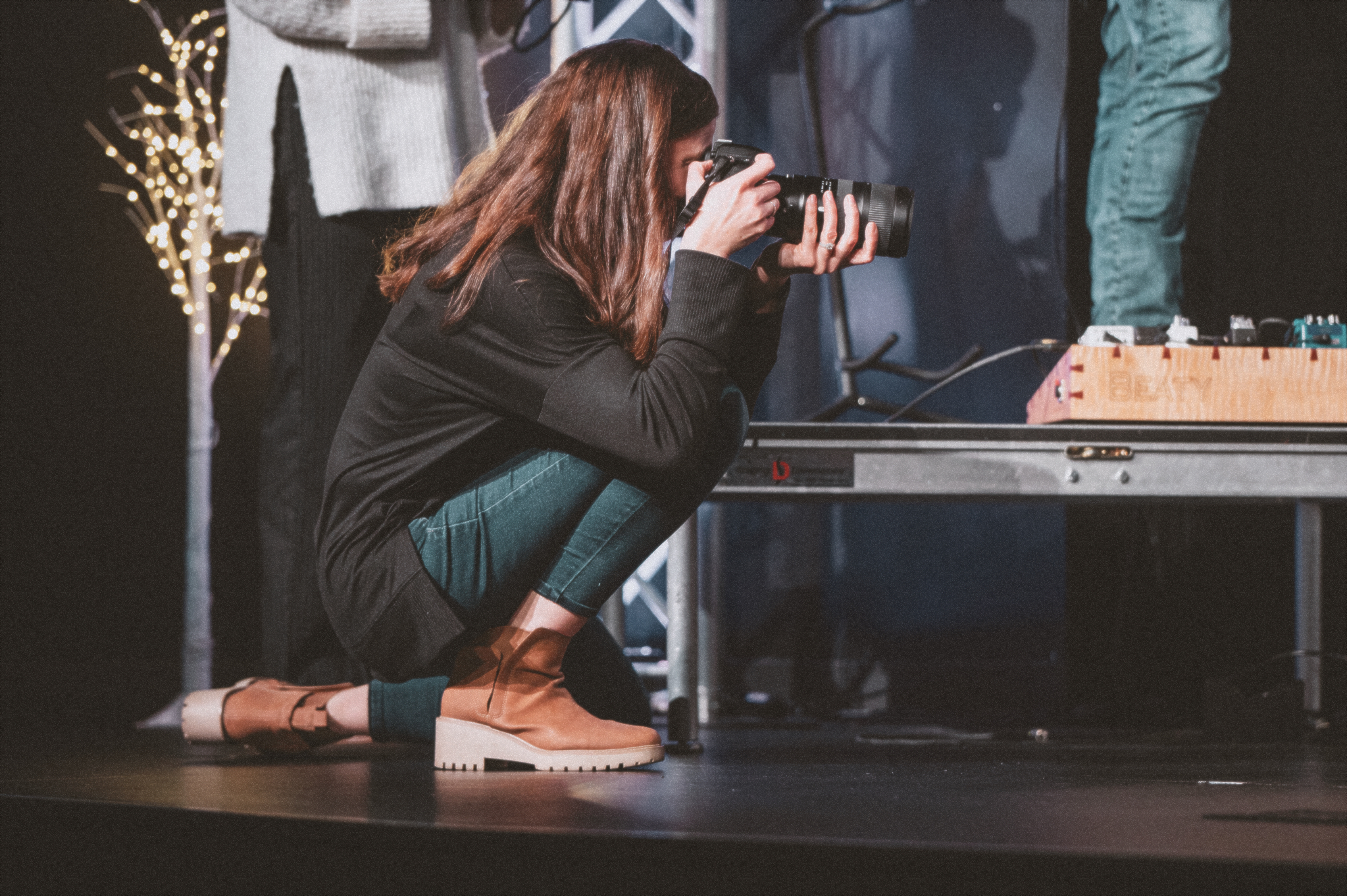 Rachel on the stage takes pictures for the church