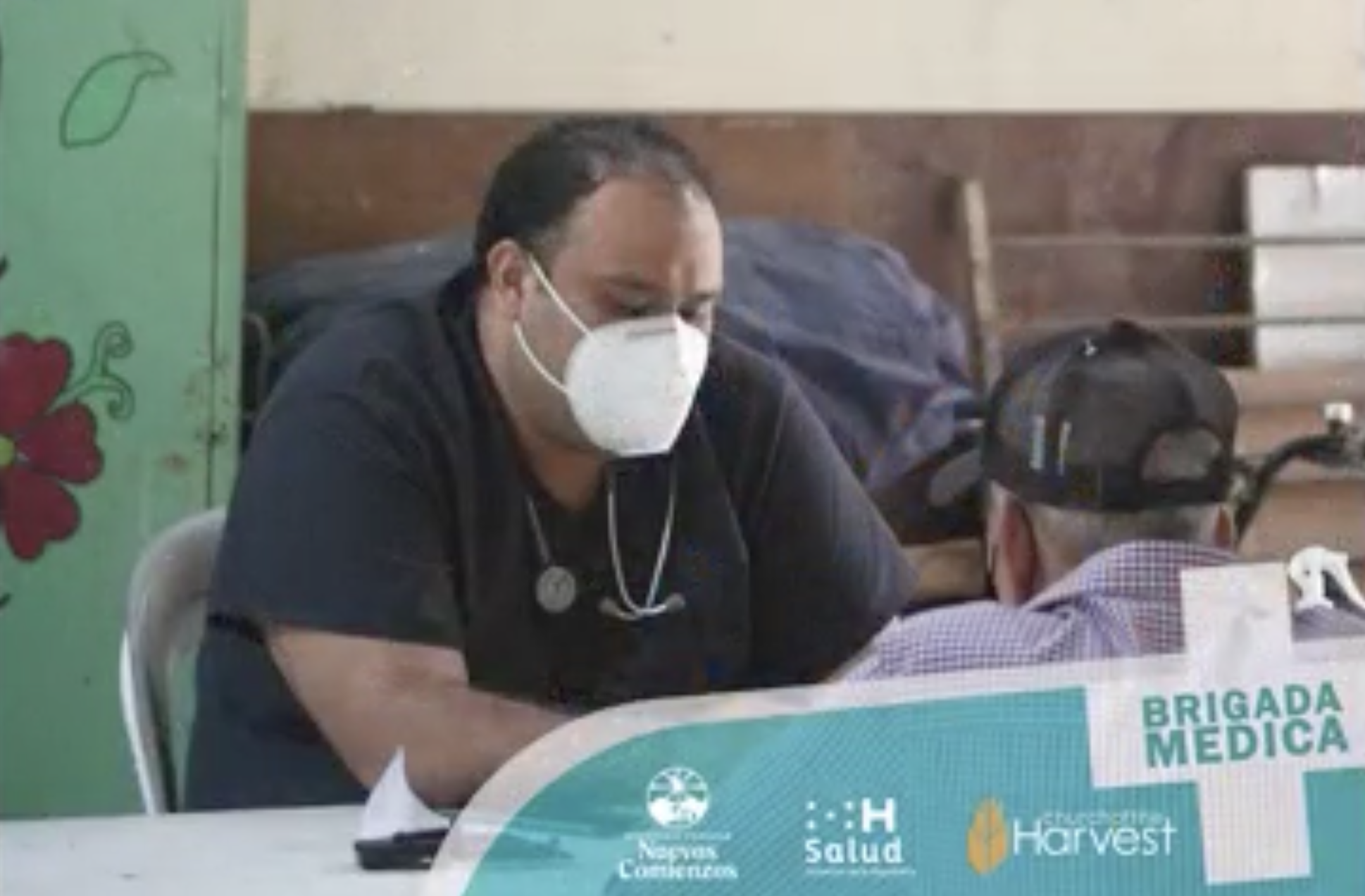 A man in a mask taking a break during medical outreach in Honduras
