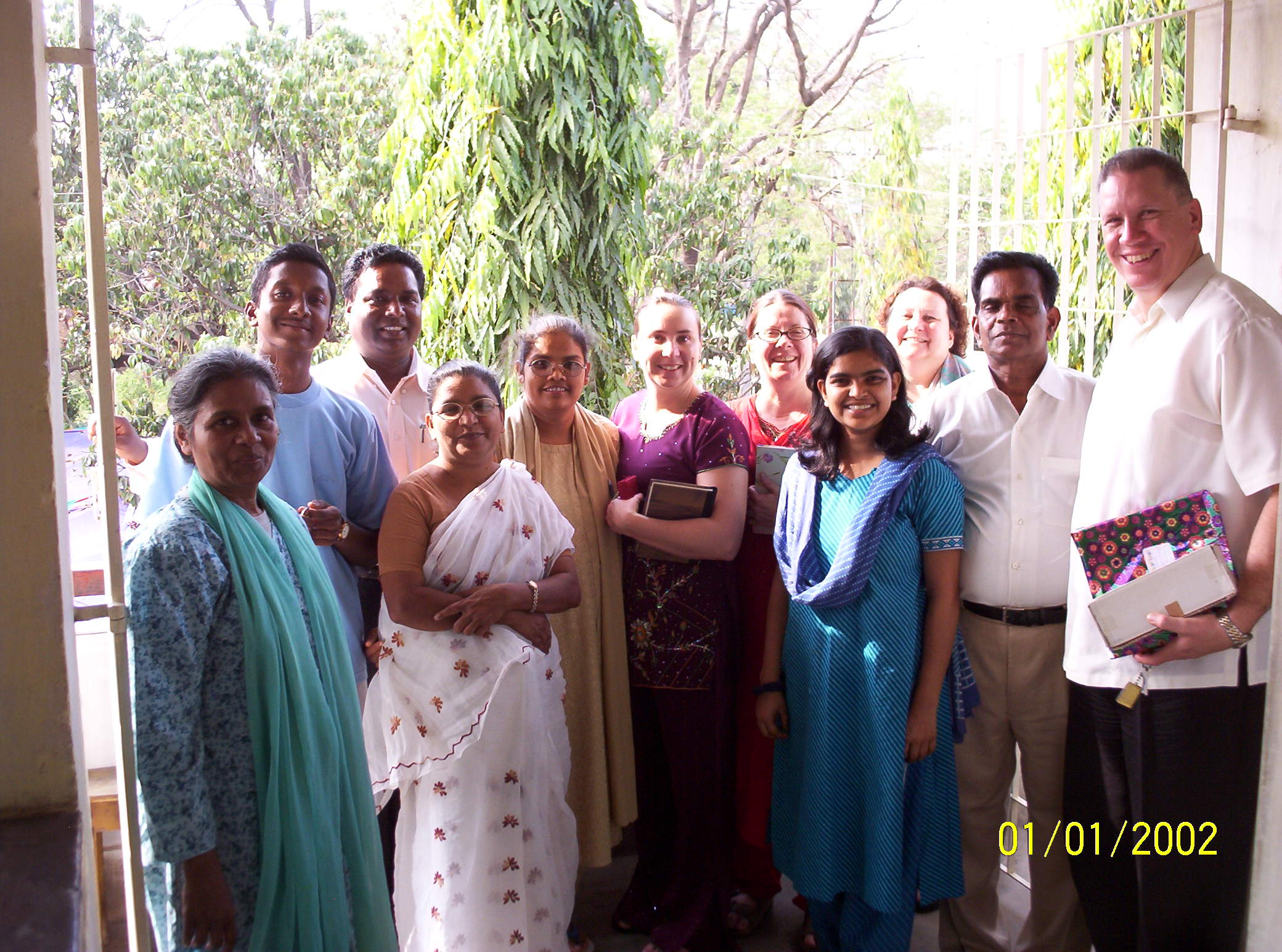 Pastor David poses for a photo with a group from a local church in India