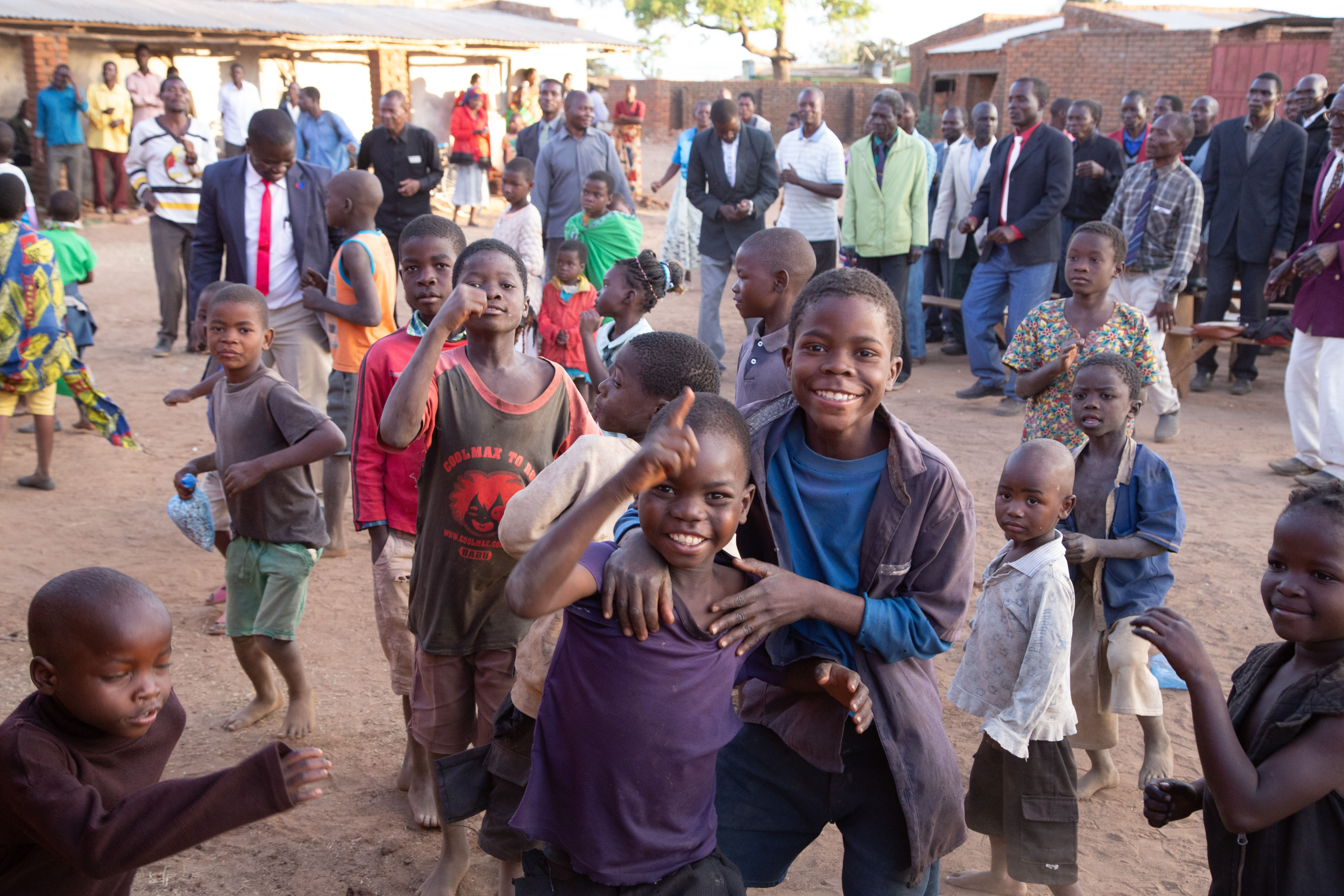 A widescreen shot of a group of smiling boys from Malawi. 