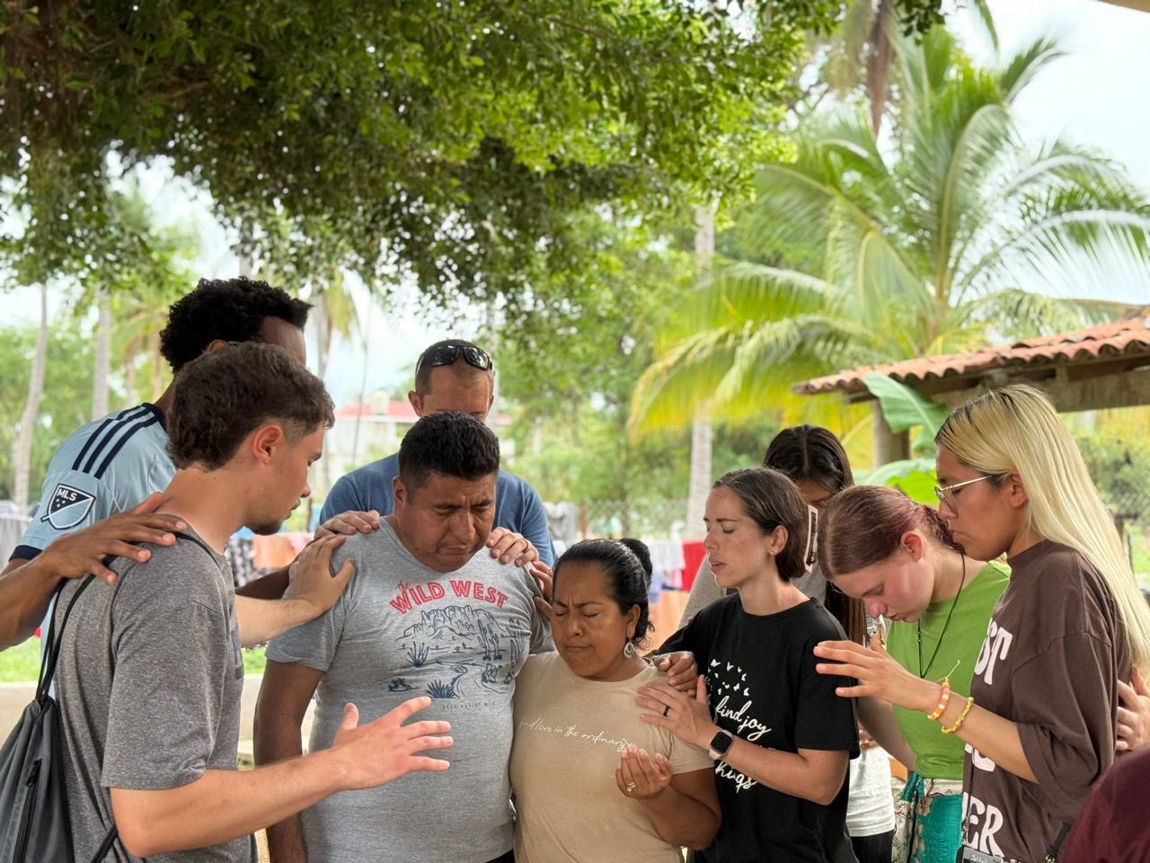 A group from Church of the Harvest praying over a couple in Roca Blanca