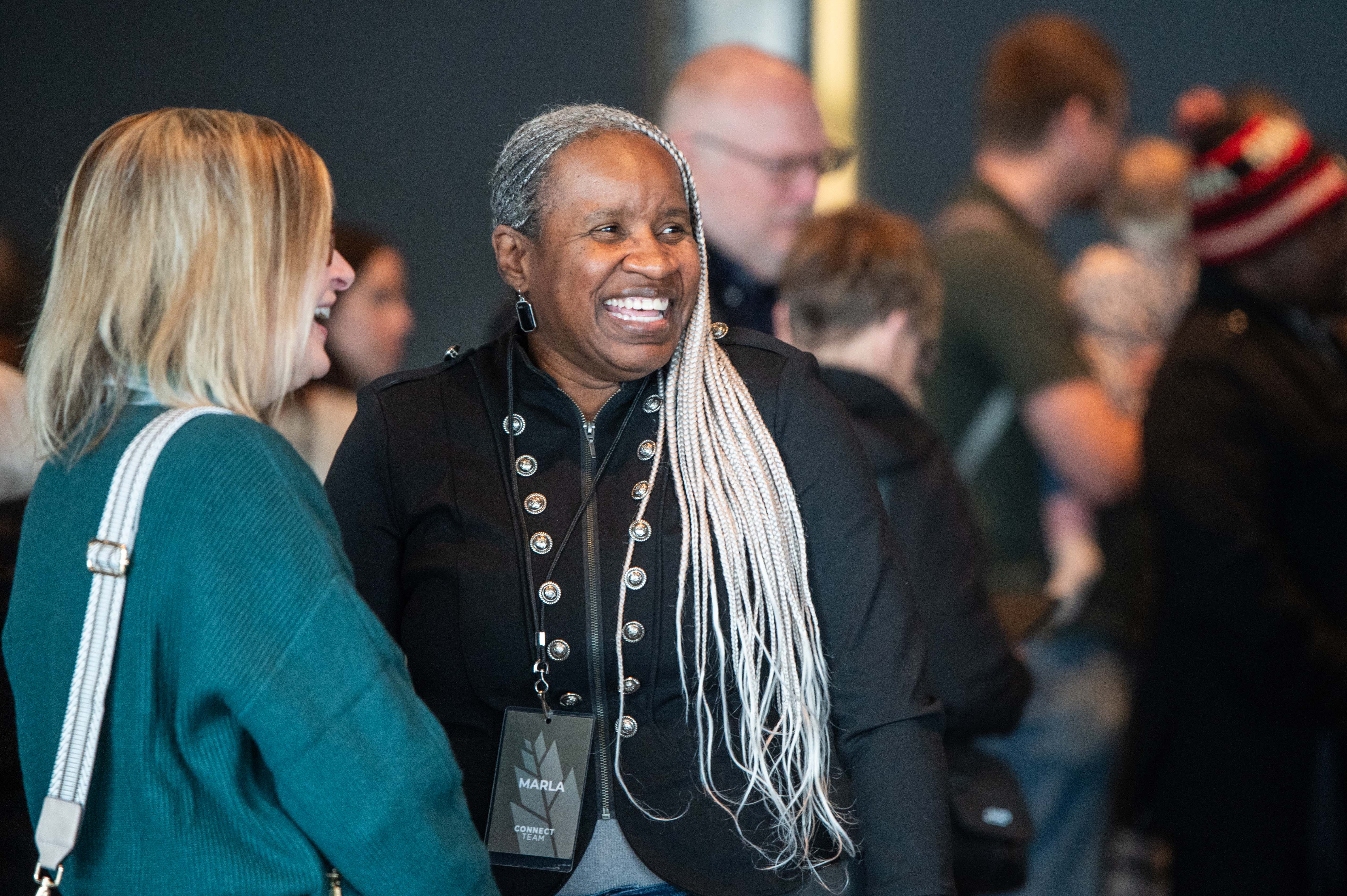 Pastor Janel and a fellow congregant smile in the lobby of the Olathe Campus. 