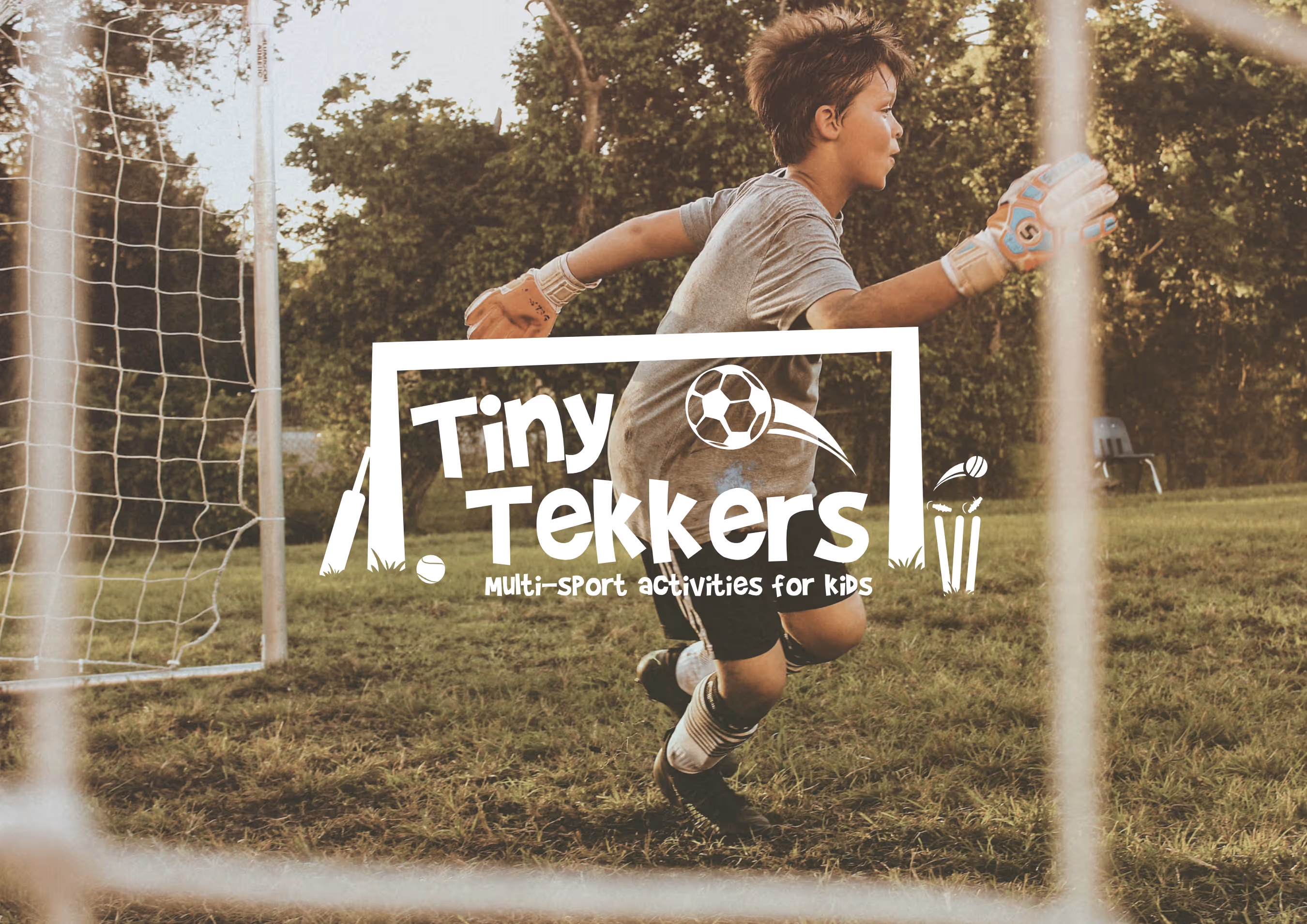 A young boy plays in goal in a game of football. The Tiny Tekkers logo sits front and centre of the screen