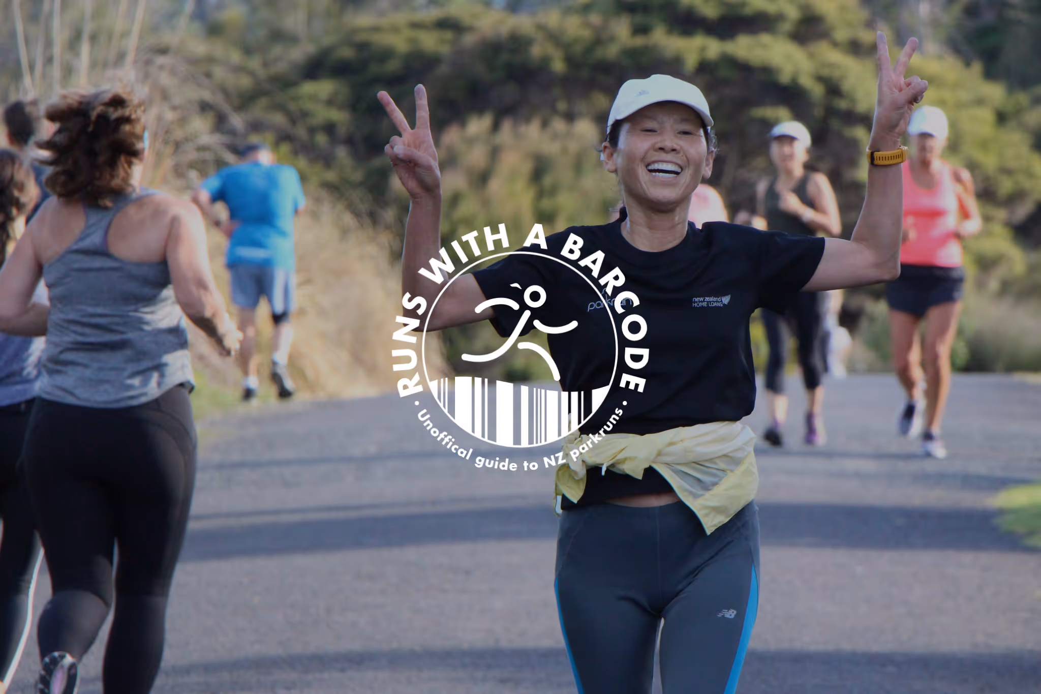 A smiling lady gives two piece signs with her hands as she runs towards the camera. The runs with a barcode logo sits in the middle of the image.