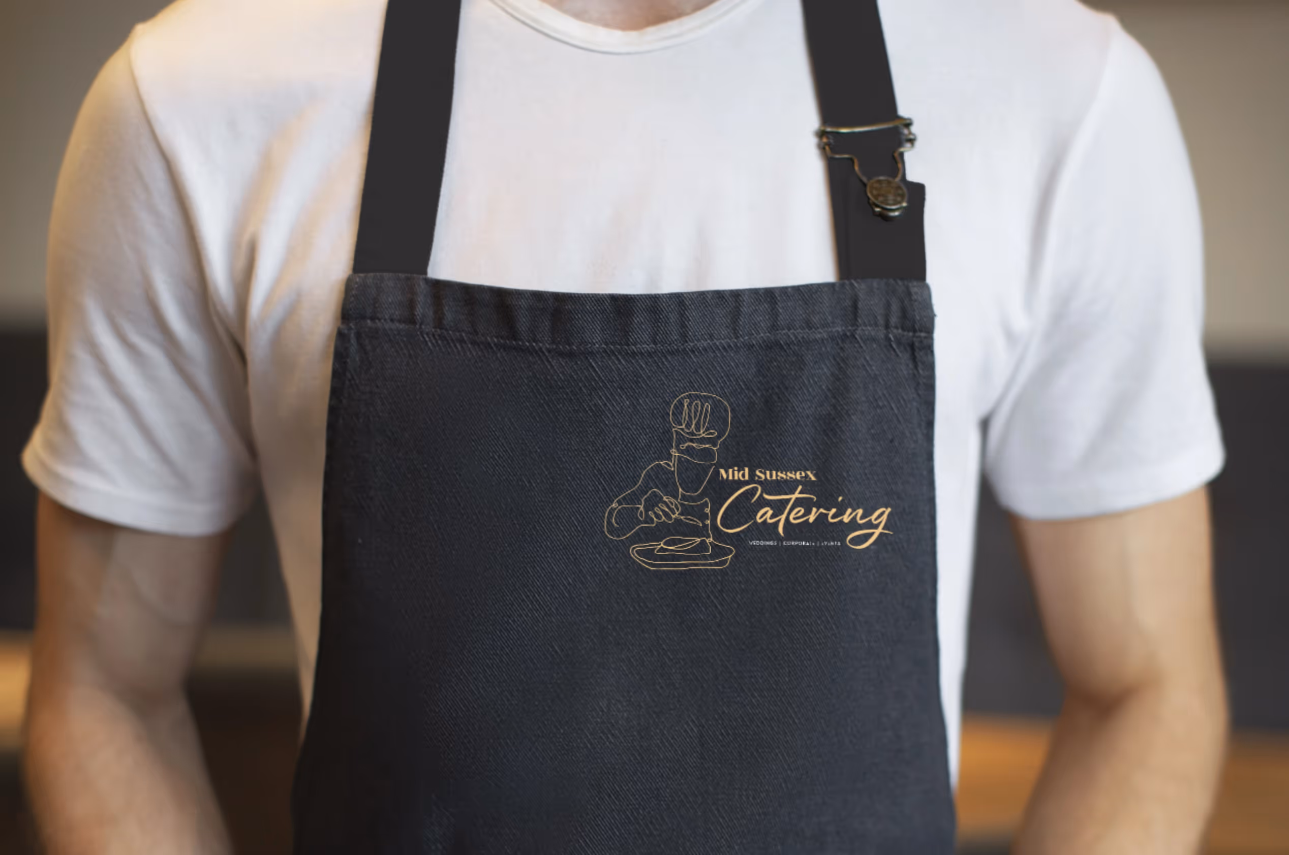 A chef's apron with the Mid Sussex Catering Branding