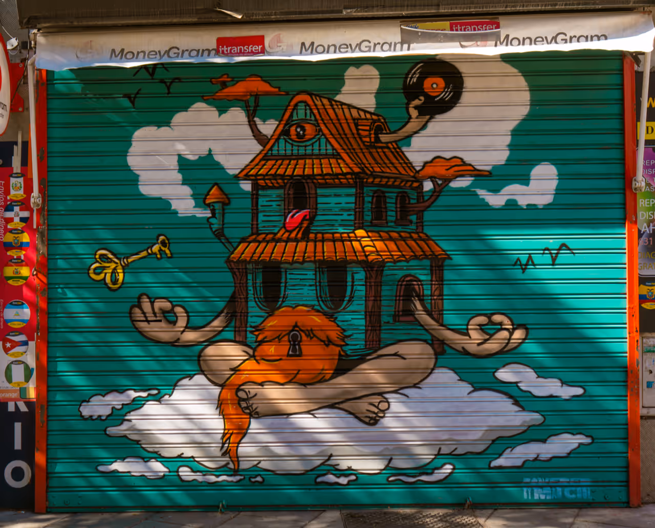 Colorful mural of a house with a keyhole on the door, meditating with arms and legs crossed on a cloud, holding a vinyl record and a golden key.