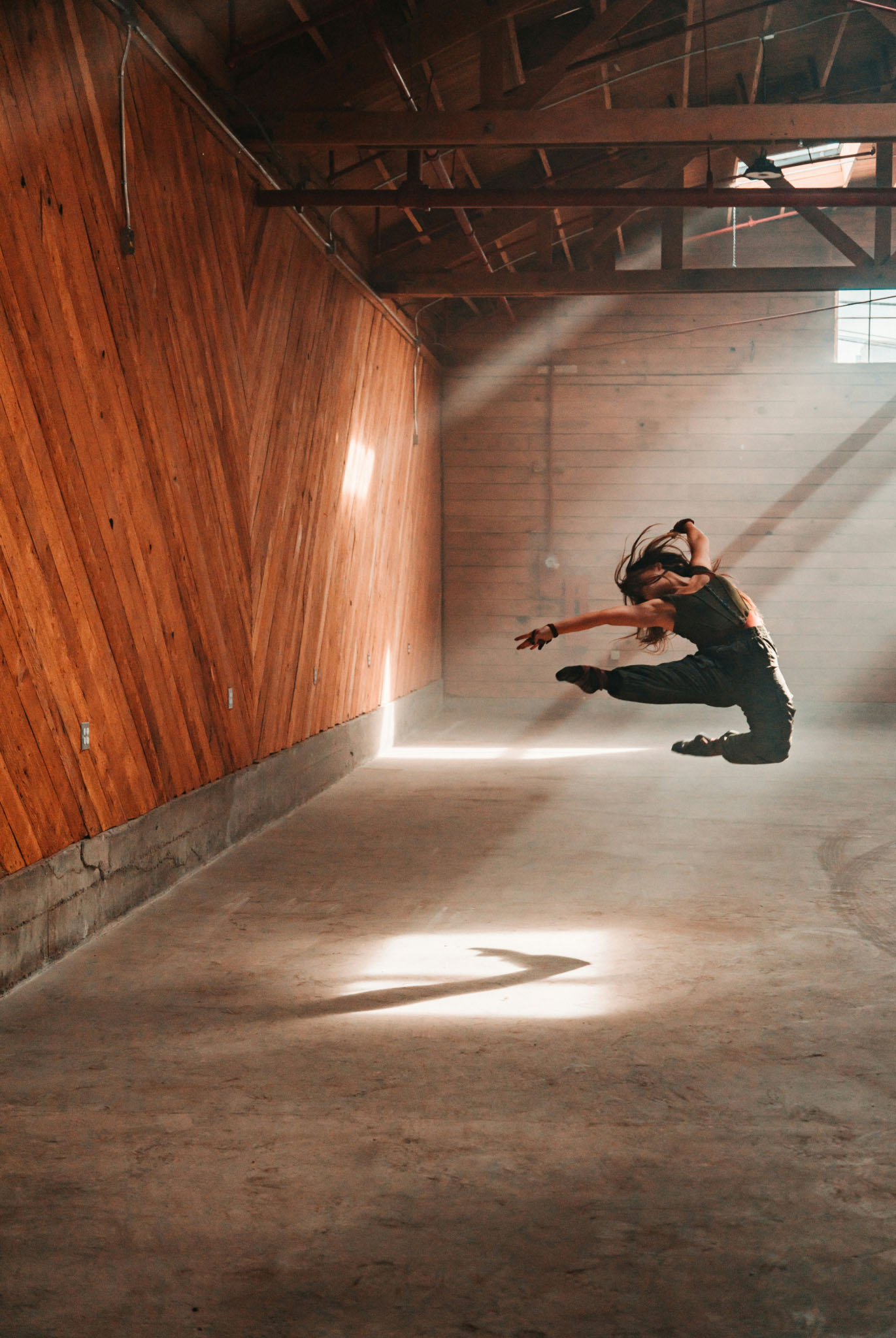 Dancer moving in a sunlit studio
