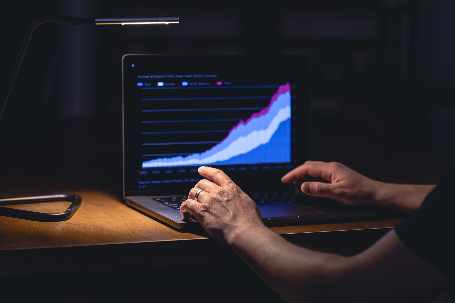Rising performance chart on a laptop screen at night