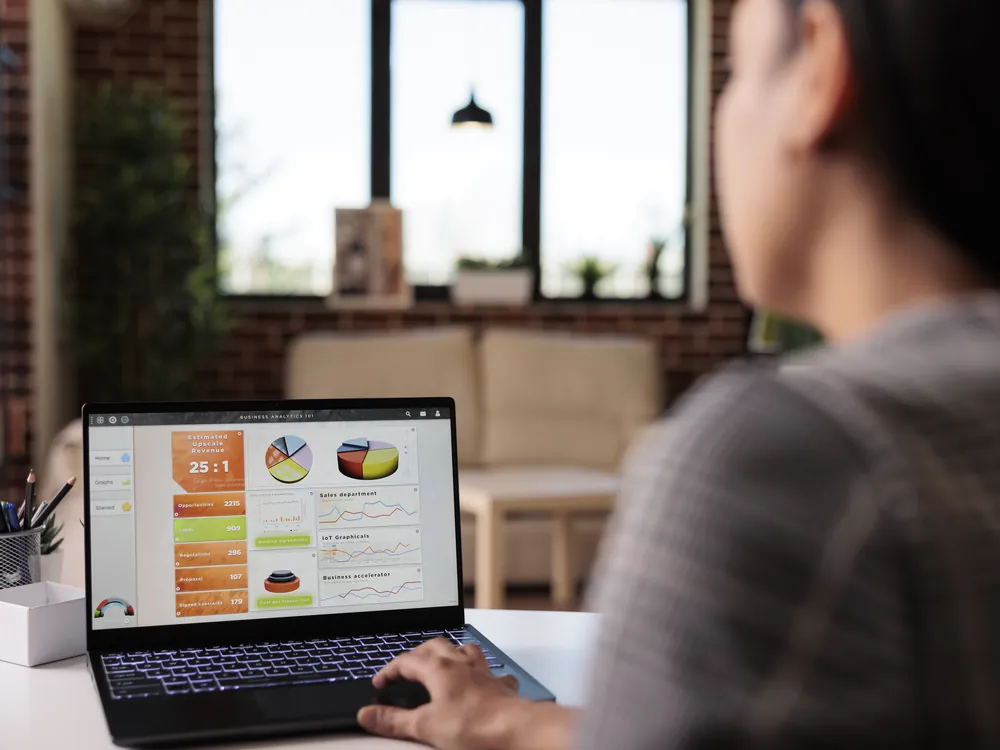 Marketer reviewing a campaign analytics dashboard on a laptop