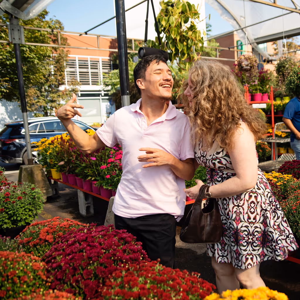 Man living with cerebral palsy with his girlfriend in a public market