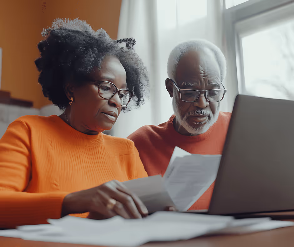 senrior married couple looking at laptop and papers - Trumbull trust lawyer discusses a powerful planning tool can protect families from common yet preventable hardships.