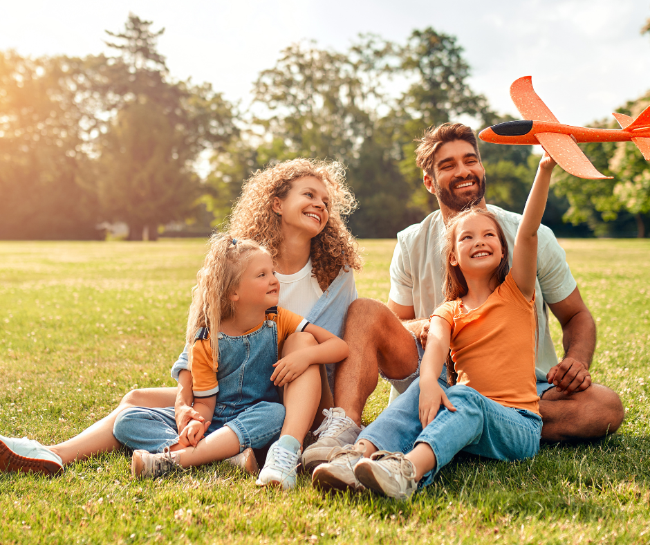 family playing on lawn with toy airplane - Trumbull estate planning lawyer